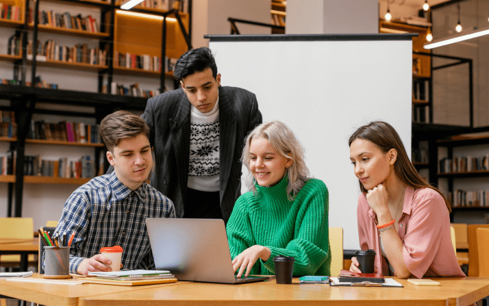 A group of students in front of laptop